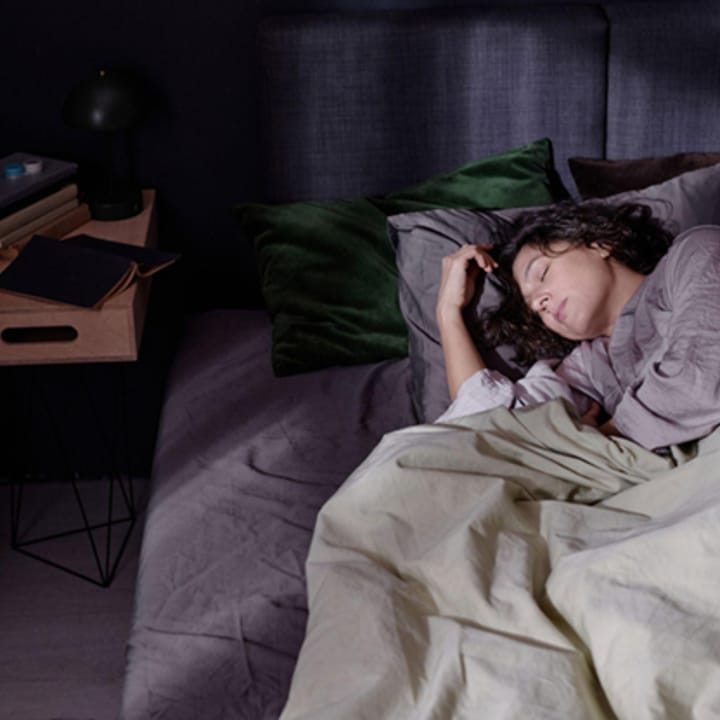 High angle shot of a tired woman sleeping in bed