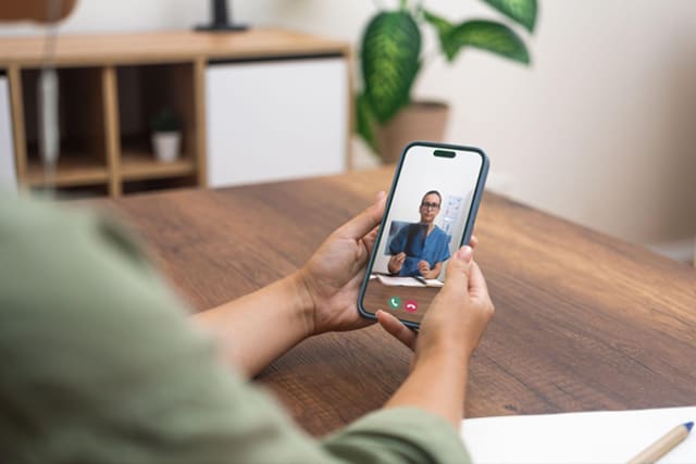 A doctor discussing a treatment plan with a patient via a digital appointment