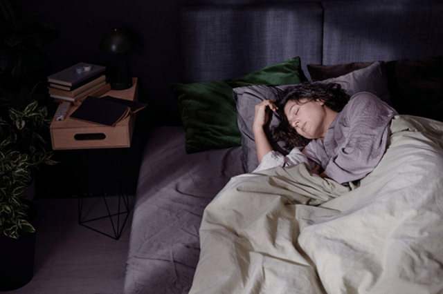 High angle shot of a tired woman sleeping in bed